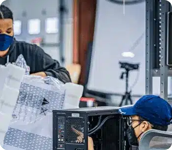 powergpu team members at their workspaces building custom gaming pcs