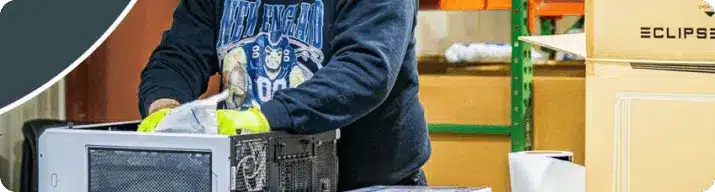 a powergpu employee preparing a gaming pc for shipping to the customer